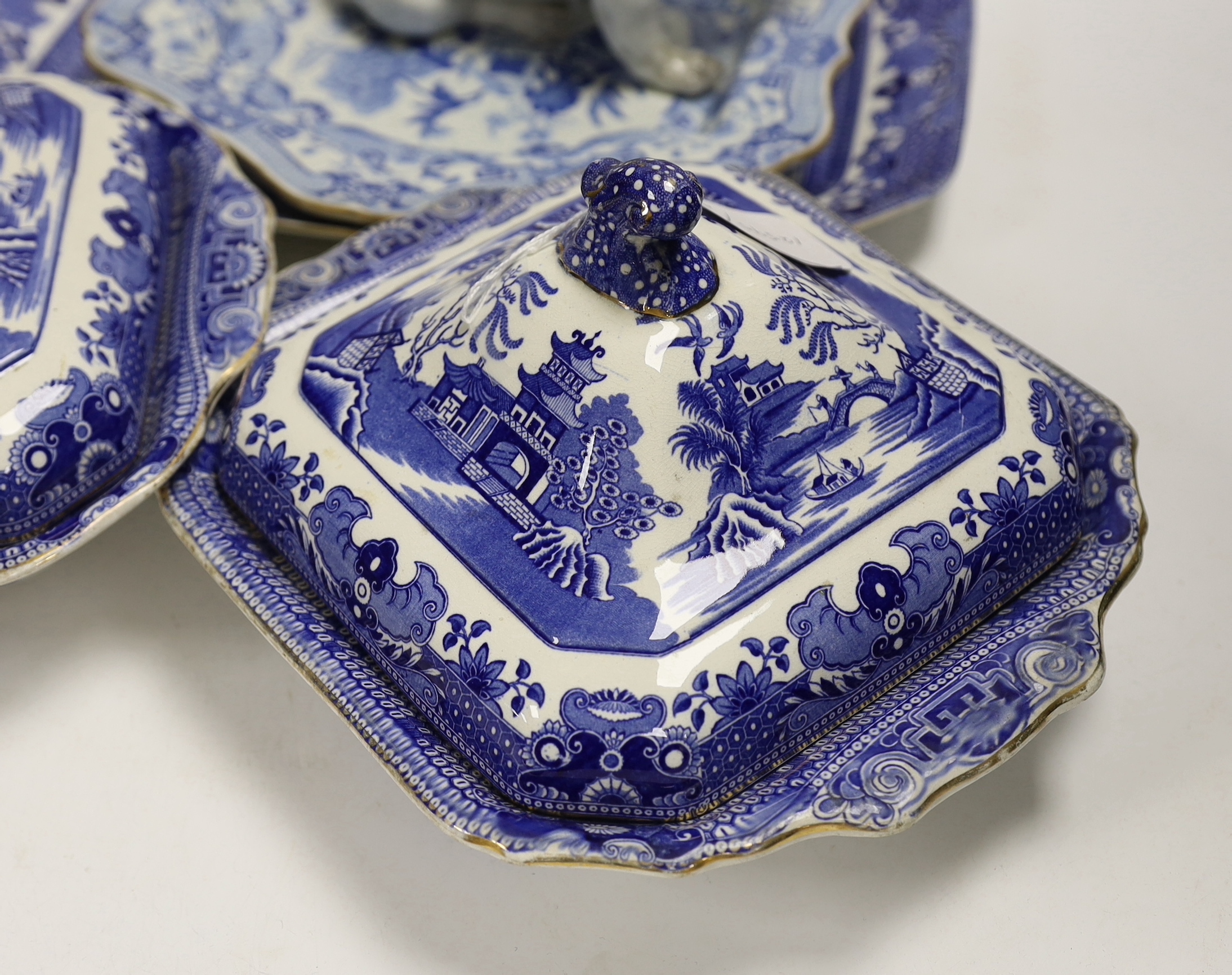 A Mason's stoneware blue and white plate, 2 tureens and a serving dish and a German model of a pug dog